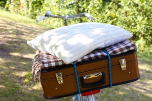 Bicycle and brown suitcase with picnic set